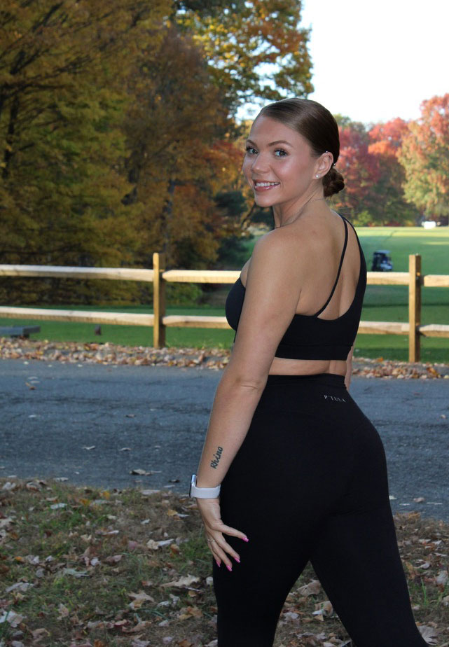 The coach is posing with fall background.